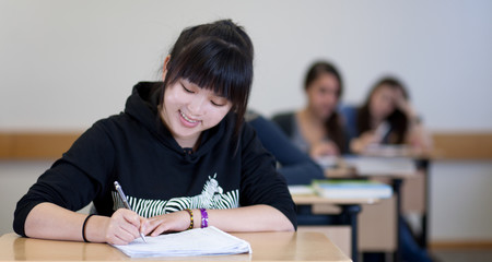 Happy Student has fun while working in classroom