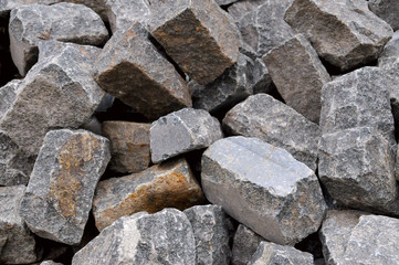 Pile of natural gray stone bricks closeup