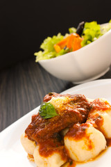 Beef with sauce and gnocchi