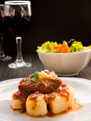 Beef with sauce and gnocchi