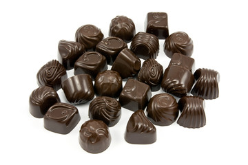 dark assorted chocolate pralines on white background
