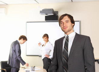 Business man with team mates discussing in the background