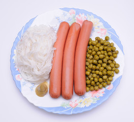 Dish with sausage, noodles and green peas