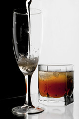 Glass of champagne and whisky with ice.