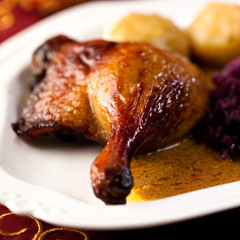 Roast duck leg with red cabbage and potato dumplings