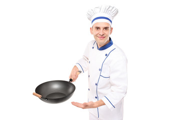 Chef holding a wok welcoming