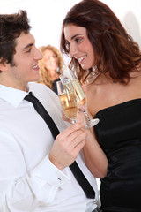 Couple celebrating new year's eve with champagne