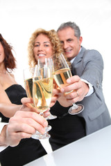 Group of friends cheering with glasses of champagne