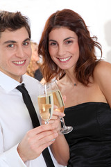 Couple celebrating new year's eve with champagne