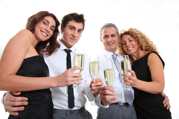 Group of friends cheering with glasses of champagne