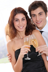 Couple celebrating new year's eve with champagne