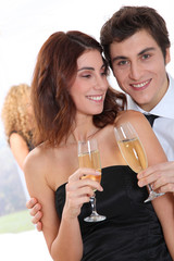 Couple celebrating new year's eve with champagne