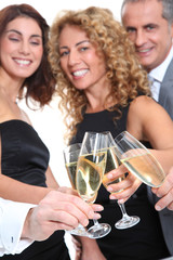 Group of friends cheering with glasses of champagne
