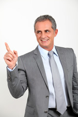 Smiling businessman standing on white background