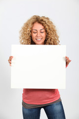 Funny blond woman holding whiteboard