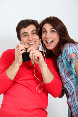 Couple having fun listening to music player