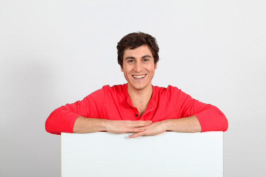 Portrait Of Young Man Holding Whiteboard