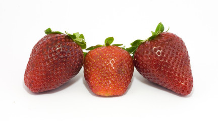 Three fresh trawberries isolated on white
