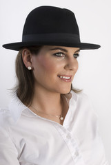 Portrait of young woman in black hat.