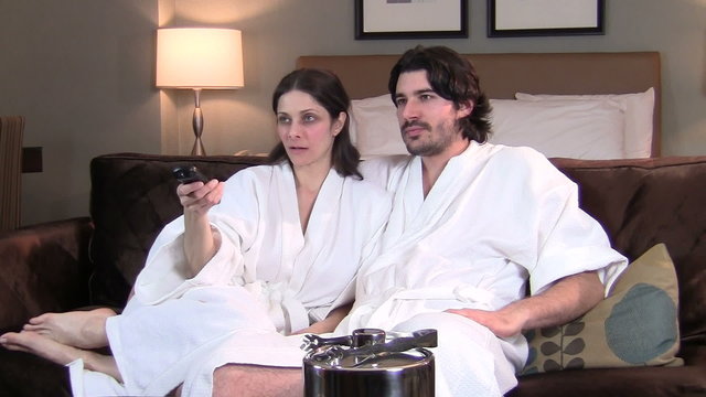 Couple in bathrobe relaxes and watches TV - HD