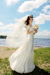 Fototapeta na wymiar Young beautiful bride posing outside