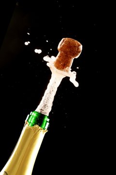 Cork Shooting Out Champagne Bottle
