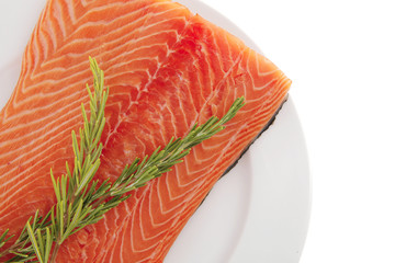 salmon fillet on white plate and rosemary