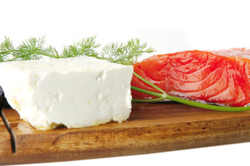 pink salmon on wooden plate with cheese