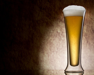 mug of beer against a stone wall