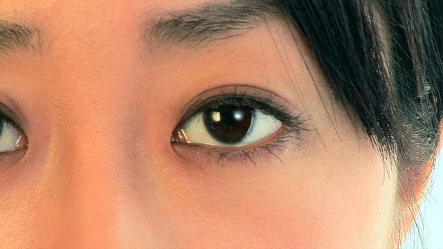 Close-up portrait of young Asian woman eyes blinking