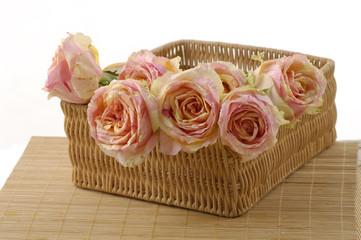 Obraz na płótnie Canvas Arrangement of pink roses in a basket