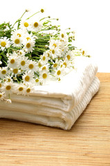 Obraz na płótnie Canvas stack of towels and nice marigolds - body care