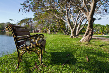 Alloy bench on the waterside in the park