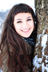 smiling young woman outdoors in winter time