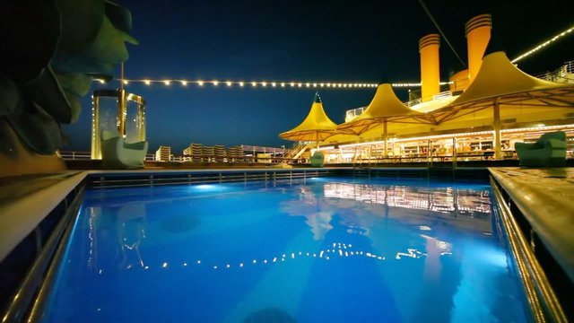 outdoor swimming pool in night cruise ship