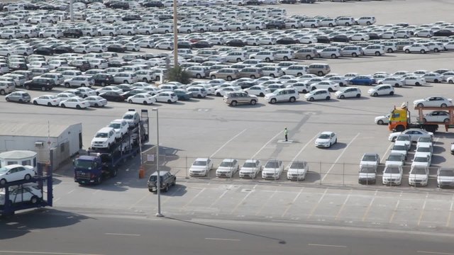 automobile transporters with new cars leaves parking