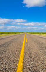 Lonely road running through the plains