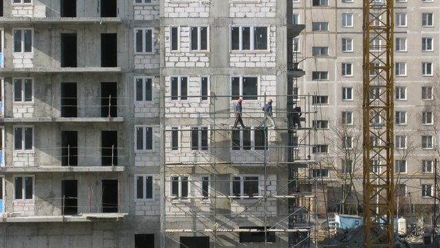 House building, builders build scaffolding