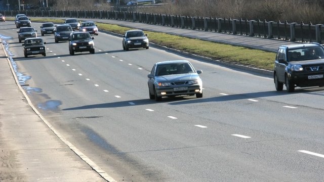 Cars are on highway in sunny day