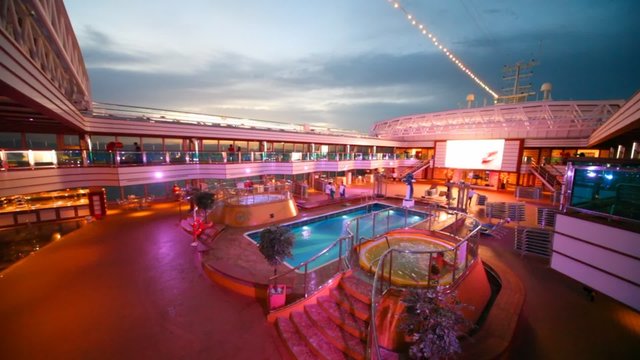 Open-air water pool on deck of cruiser in night