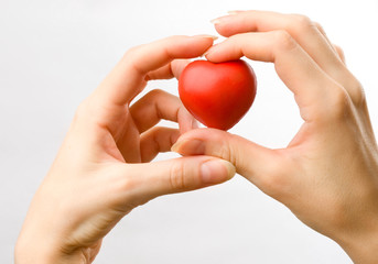 Female hands with red heart