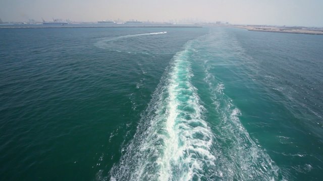 trace on water, view from top deck of cruise ship