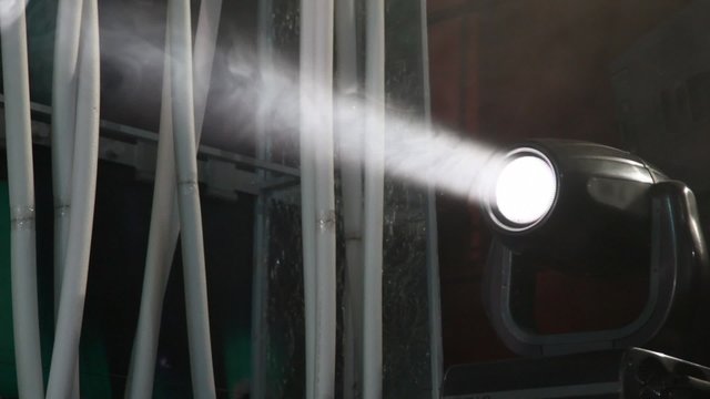 light of disco searchlight in smoke in nightclub