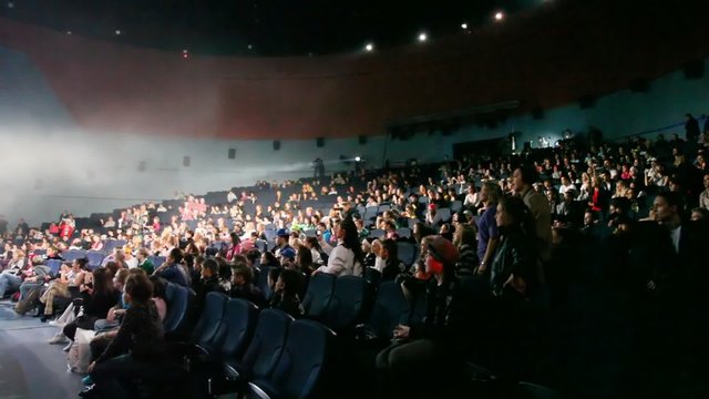defocused audience raising hands during hip-hop show