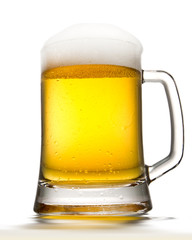 Beer into glass isolated on white