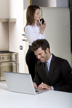 couple at home  with laptop and mobile