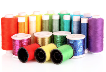 Semicircle of many-coloured bobbins of thread isolated on white