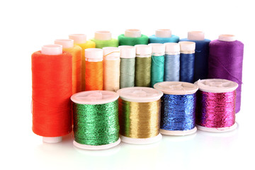 Semicircle of many-coloured bobbins of thread isolated on white