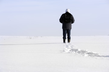 Fototapeta na wymiar adult man walking in a winter landscape