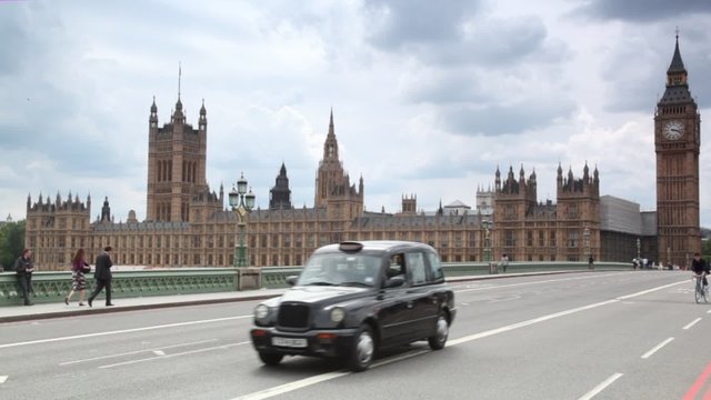 People, cars moving on Westminster Bridge, Big Ben in London